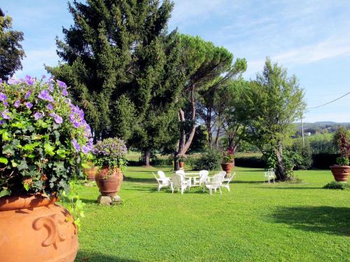 a group of chairs and flowers in a yard at Villa Laura by Interhome in Agna