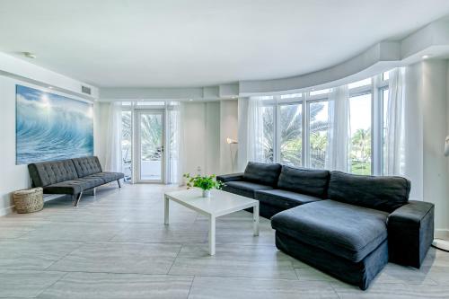 a living room with a couch and a table at Modern Ocean Drive Condo in the Heart of Sobe! in Miami Beach