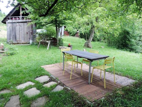 a table and chairs on a wooden deck in a yard at Holiday Home Casa Lienartova by Interhome in Grimacco