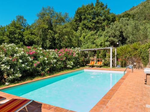 a swimming pool in a yard with flowers at Holiday Home Iacopo by Interhome in Pieve a Nievole
