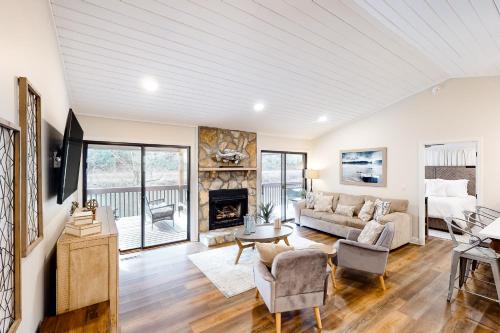 a living room with a couch and a fireplace at North River Views in Sylva