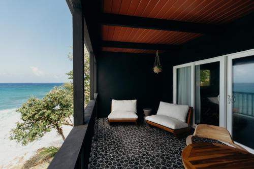 a balcony with two chairs and a view of the ocean at The Waves at Cane Bay in Kingshill