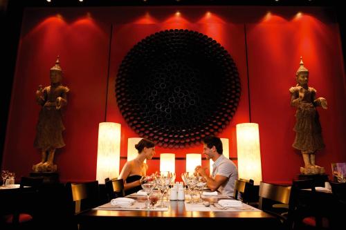 two people sitting at a table in a restaurant at Riu Emerald Bay - All Inclusive in Mazatlán