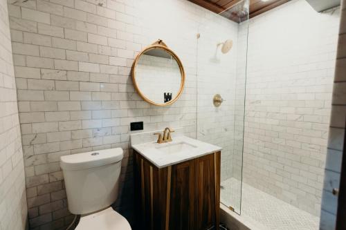 a bathroom with a toilet and a sink and a mirror at The Waves at Cane Bay in Kingshill