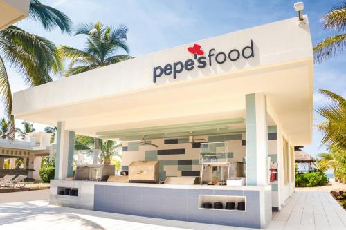 a pepsi store with palm trees in the background at Riu Emerald Bay - All Inclusive in Mazatlán