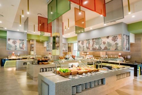 a buffet line in a restaurant with food at Riu Emerald Bay - All Inclusive in Mazatlán