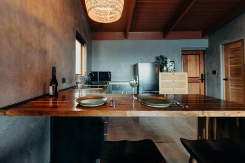 a kitchen with a counter with glasses and a bottle of wine at The Waves at Cane Bay in Kingshill