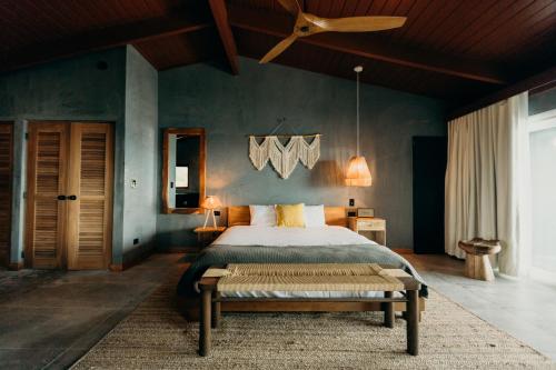 a bedroom with a large bed and a ceiling fan at The Waves at Cane Bay in Kingshill