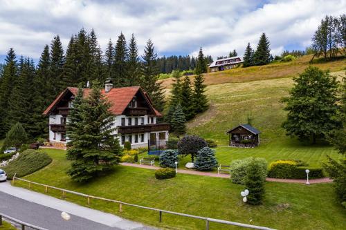 a house sitting on top of a hill at Hotel Resort Martin & Kristyna in Špindlerův Mlýn