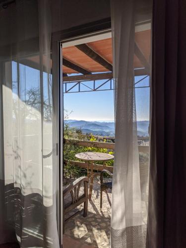 a glass door leading to a patio with a table at Hotel Fuente del Sol in Antequera