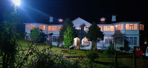 a large building with lights on it at night at Rani Kothi Heritage Residency in Darjeeling