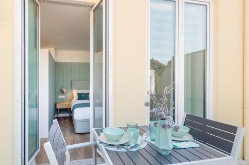 a dining room table with a view of a bedroom at 7 Bridges Estúdios- Porto-houses and suites in Porto