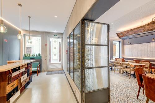 a dining room with a glass case with wine bottles at 7 Bridges Estúdios- Porto-houses and suites in Porto