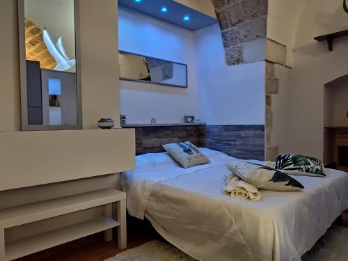 a bedroom with a white bed with a mirror at TERRAZZE BS in Rutigliano