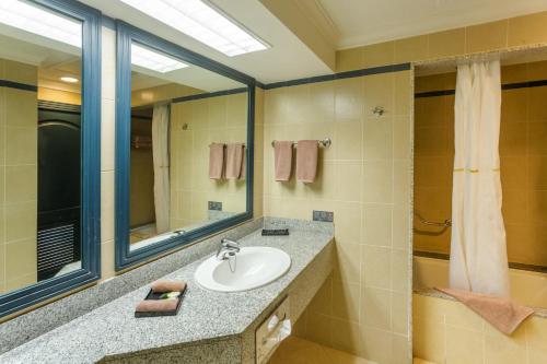 a bathroom with a sink and a mirror at Riu Emerald Bay - All Inclusive in Mazatlán