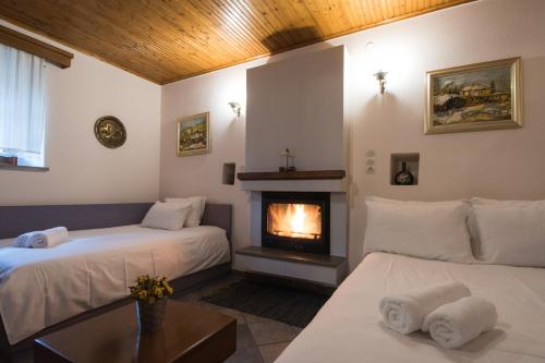 a room with two beds and a fireplace at Rodami in Kalentzi
