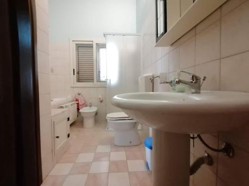 a bathroom with a sink and a toilet at CASA MICHELE in Marinella di Selinunte