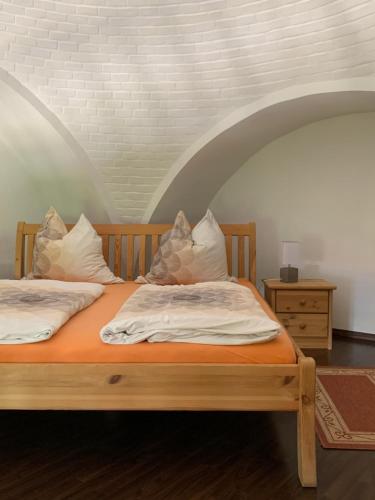 two beds in a room with an arched ceiling at Historisches Gebäude " Rentmeisteramt" Basedow in Basedow