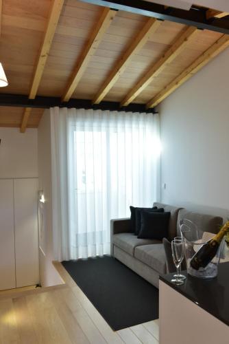 a living room with a couch and a large window at The Castle House in Lamego