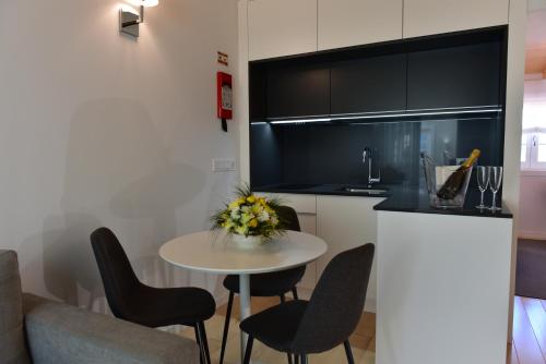 a small kitchen with a small table and chairs at The Castle House in Lamego