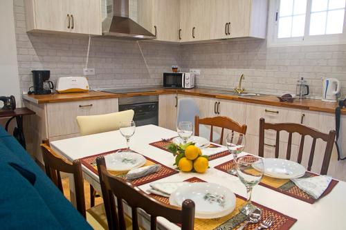 a kitchen with a table with plates and wine glasses at Casa Celia - Casitas las Abuelas - vida rural in Breña Alta