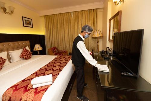 a man in a hotel room with a mask on at Hotel Paramos Inn in Bengaluru