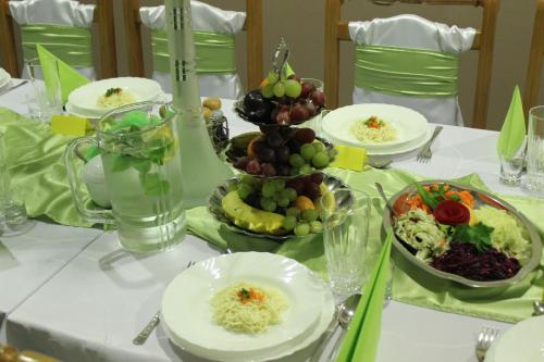 biały stół z talerzami z jedzeniem na nim w obiekcie Hotel Czardasz we Wrześni