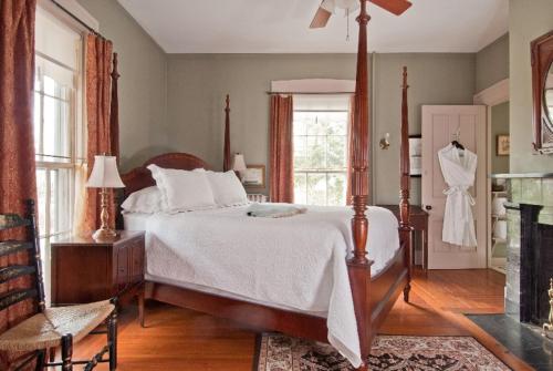 a bedroom with a large bed and a fireplace at Marshall Slocum Inn in Newport