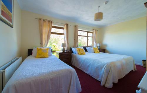 מיטה או מיטות בחדר ב-Aisleigh Guest House