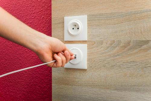 a persons hand turning on a light switch at hotelF1 La Rochelle Angoulins "Rénové" in Angoulins