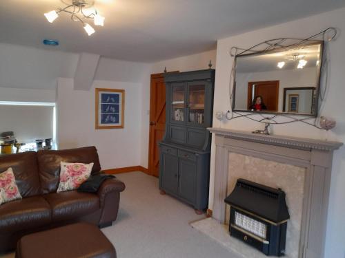 ein Wohnzimmer mit einem Kamin und einem Spiegel in der Unterkunft Travellers Rest Apartment in Beverley