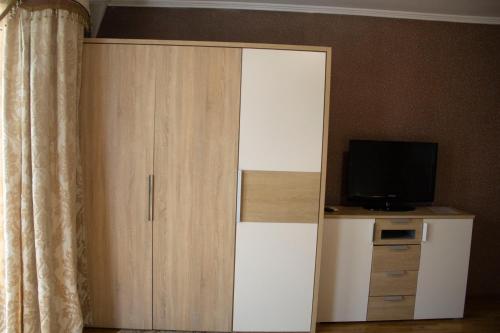 a white cabinet with a television on top of it at Kristall Hotel in Bosteri