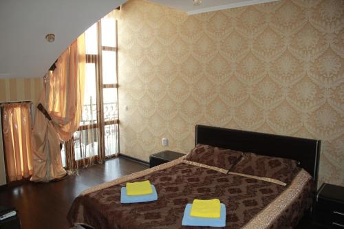 a bedroom with a bed with two towels on it at Kristall Hotel in Bosteri