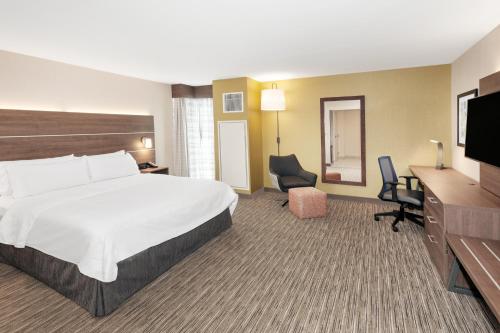a hotel room with a large bed and a desk at Holiday Inn Express & Suites - Ottawa Downtown East, an IHG Hotel in Ottawa
