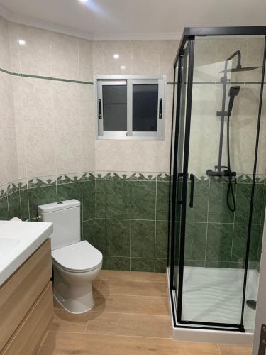 a bathroom with a toilet and a glass shower at UIM Mediterraneo Buenavista Wifi in Puerto de Sagunto