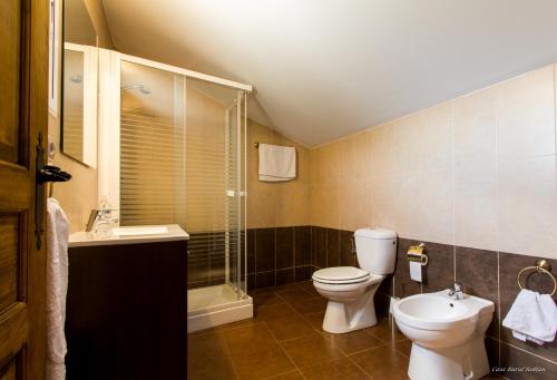 a bathroom with a toilet and a shower and a sink at Casa Roblan in Carcastillo