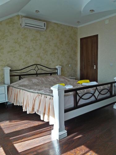 a bedroom with a large bed in a room at Kristall Hotel in Bosteri