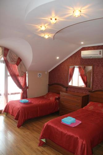 a bedroom with two beds and a mirror at Kristall Hotel in Bosteri