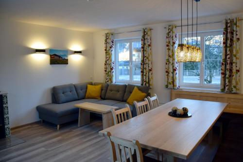 a living room with a table and a couch at Alpenvereinshaus Pruggern in Pruggern