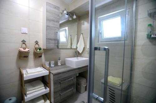 a bathroom with a shower and a sink and a mirror at Villa Susann in Šibenik