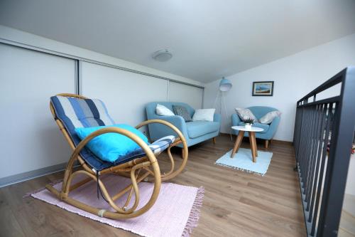 a living room with two chairs and a couch at Villa Susann in Šibenik
