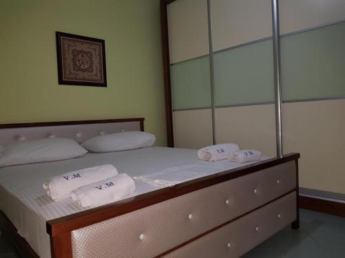 a bedroom with a bed with towels on it at Villa Meminaj Vlore Sea view and Garden Vlore in Vlorë