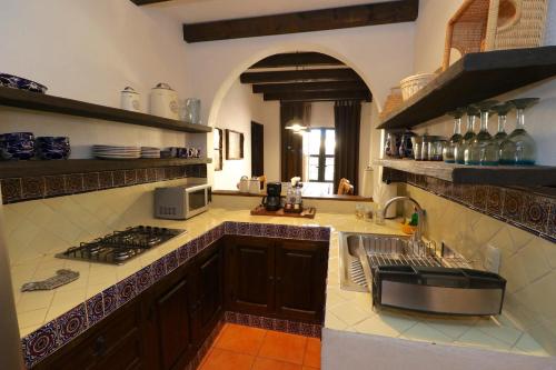 a large kitchen with a sink and a stove at Casa Mia Suites in San Miguel de Allende