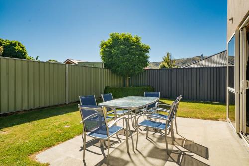 a table and chairs sitting on a patio at Southern Belle - Cromwell Holiday Home in Cromwell