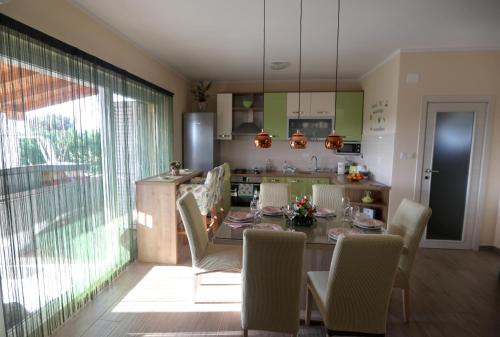 a kitchen and dining room with a table and chairs at Villa Susann in Šibenik