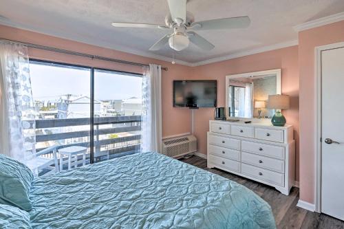 a bedroom with a bed and a window with a view at Beach Condo with Pool Access, 1 Block to the Ocean! in Myrtle Beach