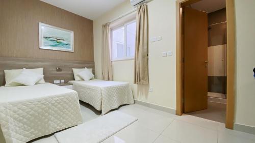 a hotel room with two beds and a window at Vista Point - Cast Renting in Msida