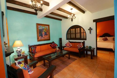 a living room with two couches and a bed at Casa Mia Suites in San Miguel de Allende