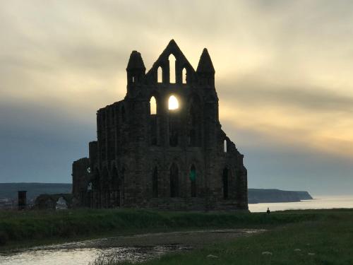 an old castle on the shore of the water at Riverview Apartment with Private Parking in Whitby