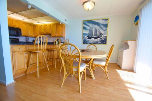 a kitchen and dining room with a table and chairs at Thunder Island 141D in Ocean City
